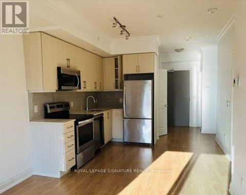 A kitchen with white cabinets and stainless steel appliances.