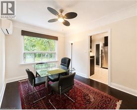 A room with a table and chairs and a ceiling fan.