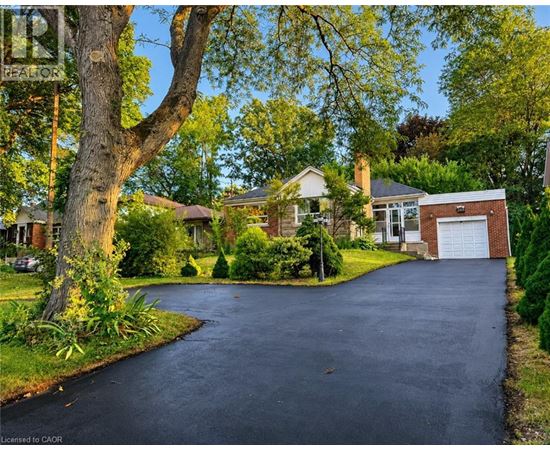 A residential area with a driveway and houses.