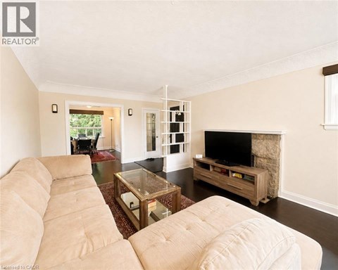A living room with a beige couch and a television.