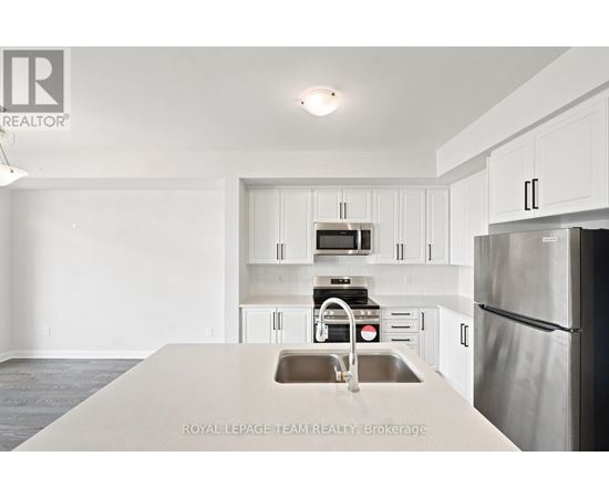 A kitchen with white cabinets and stainless steel appliances.