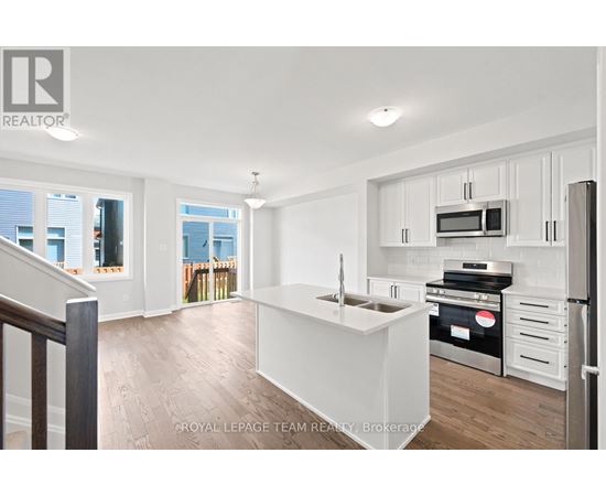 A white kitchen with a stove top oven and microwave.