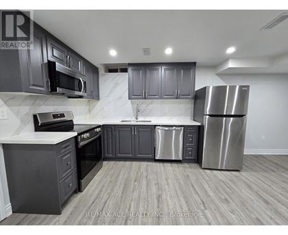 A kitchen with a stainless steel refrigerator, oven, and microwave.