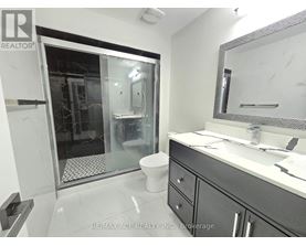 A bathroom with a toilet, sink, and shower.