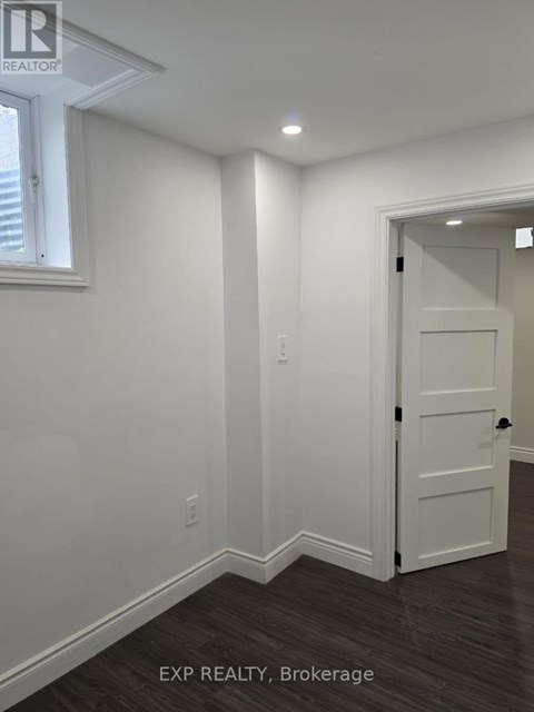 A white door is in a room with white walls.