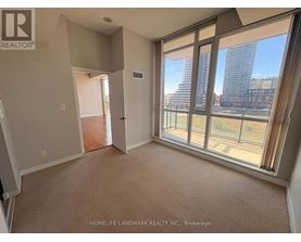 A room with a view of a city skyline through large windows.