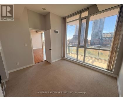 A room with a view of a city skyline through large windows.