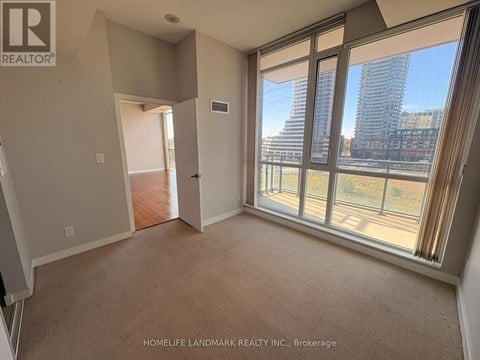 A room with a view of a city skyline through large windows.