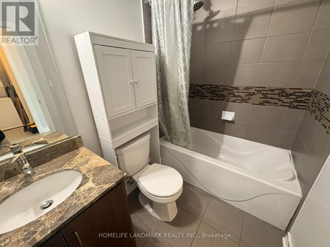 A bathroom with a toilet, sink, and bathtub.