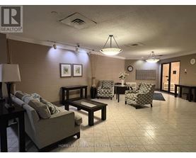 A living room with a couch, chairs, and a coffee table.