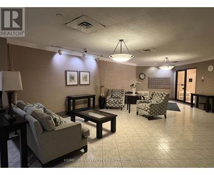 A living room with a couch, chairs, and a coffee table.