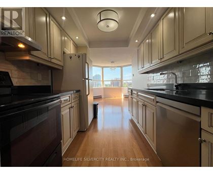 A kitchen with wooden cabinets and black countertops.