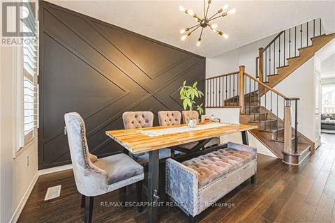 A dining room with a wooden table and chairs.