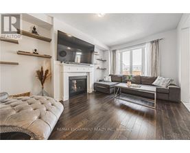 A living room with a fireplace and a grey sofa.