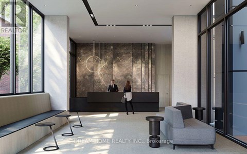 A woman is standing in a modern office lobby.