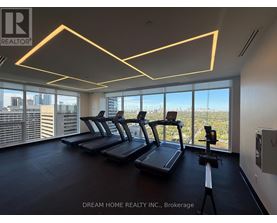 A gym with treadmills and a view of the city.