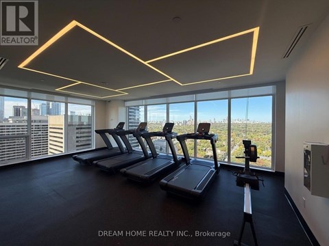 A gym with treadmills and a view of the city.