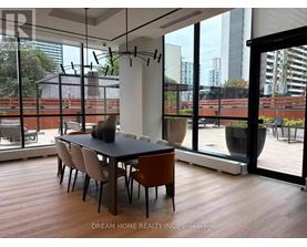 A modern dining room with a table set for four.