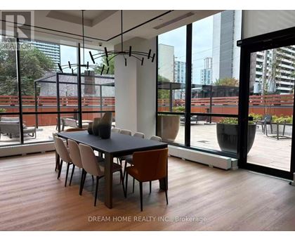 A modern dining room with a table set for four.