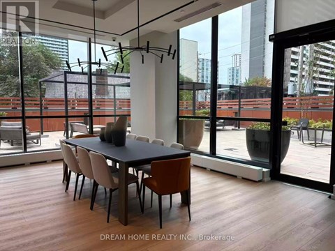 A modern dining room with a table set for four.
