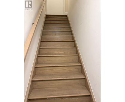 A set of wooden stairs leading upwards.