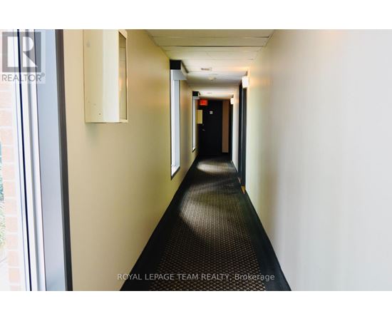 A long hallway with a Royal LePage Team Realty Brokerage sign on the wall.