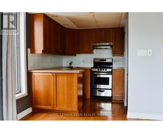 A kitchen with wooden cabinets and a black stove top oven.