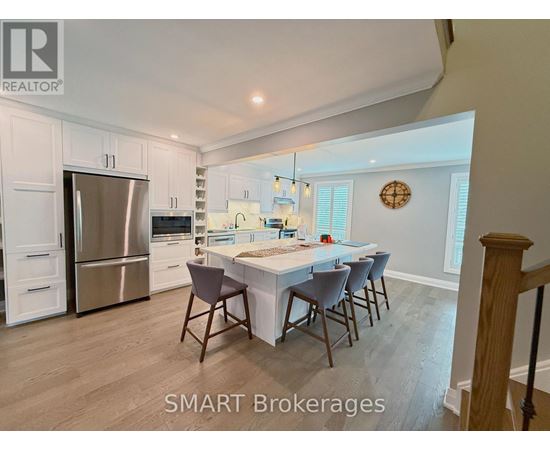A kitchen with a table and chairs in the middle of the room.