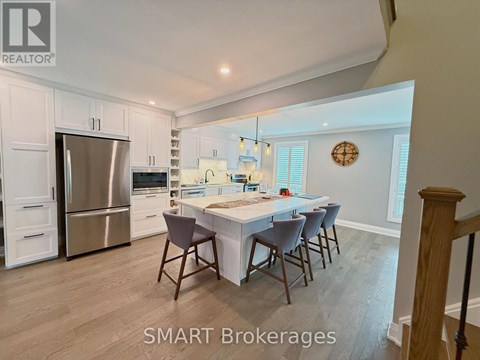 A kitchen with a table and chairs in the middle of the room.