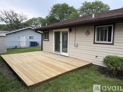 A wooden deck in front of a house.