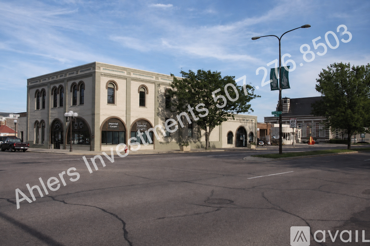 A street view of a building with a car parked in front.