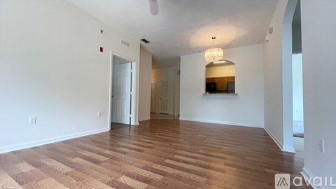 A room with wooden flooring and a ceiling fan.