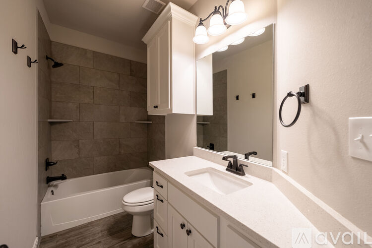A bathroom with a white sink and a white toilet.