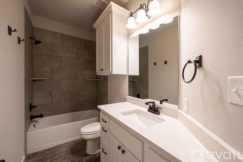A bathroom with a white sink and a white toilet.