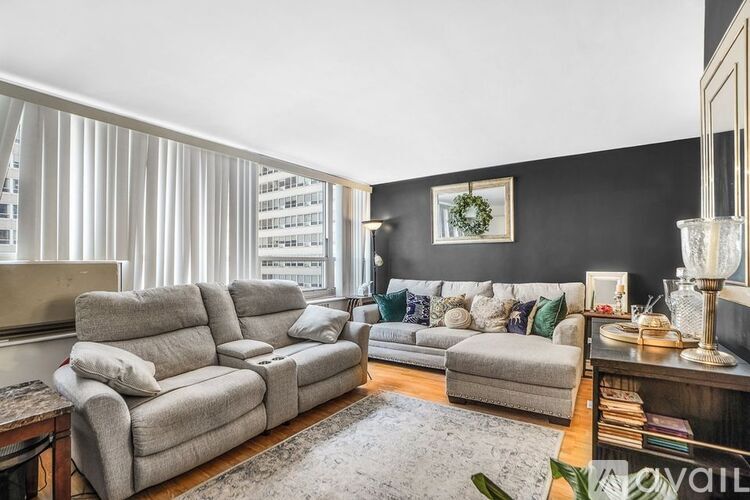 A living room with a grey sofa set and a coffee table.