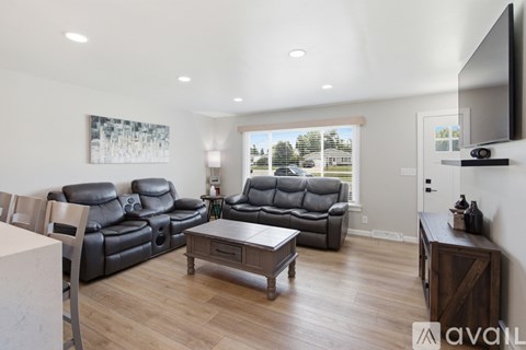 A living room with a grey sofa and a wooden coffee table.