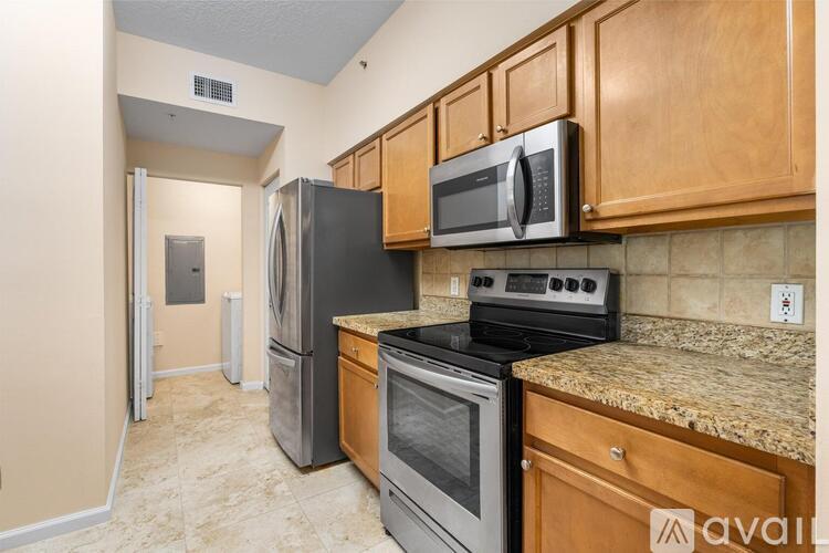 A kitchen with wooden cabinets and granite countertops.