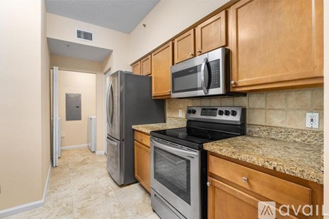 A kitchen with wooden cabinets and granite countertops.