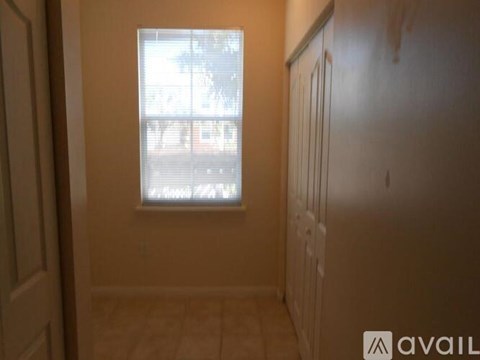 A room with a window and a door.