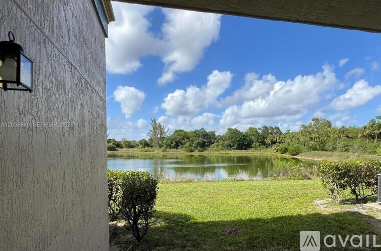 A house with a view of a lake and trees.