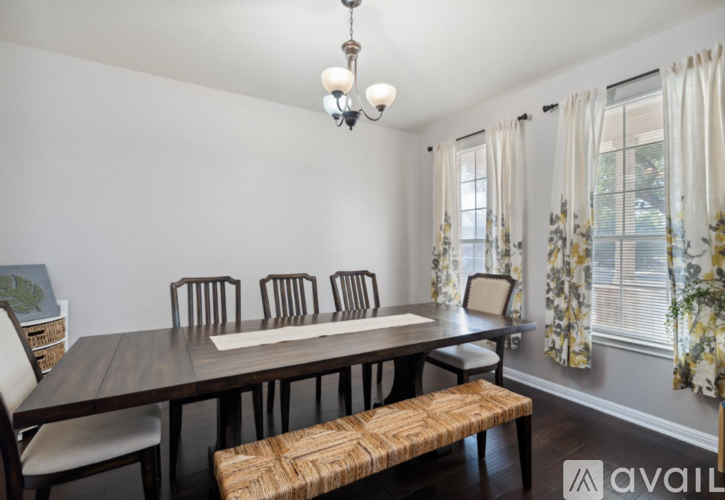 A dining room with a wooden table and chairs.