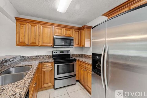 A kitchen with wooden cabinets and stainless steel appliances.