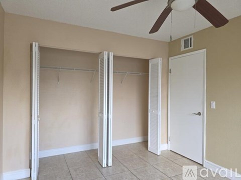 A room with a ceiling fan and a door is available for rent.
