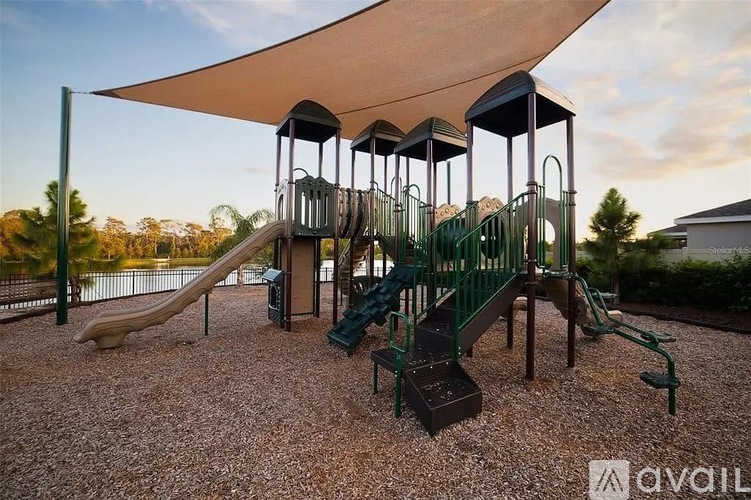 A playground with a green slide and a brown slide.