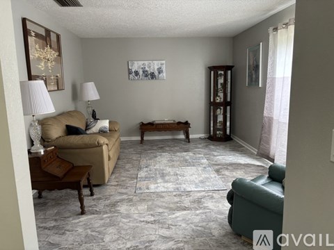 A living room with a couch, a coffee table, and a lamp.