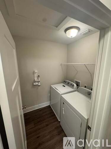 A small laundry room with a washer and dryer.