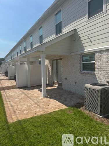 A row of houses with a grassy area in front.