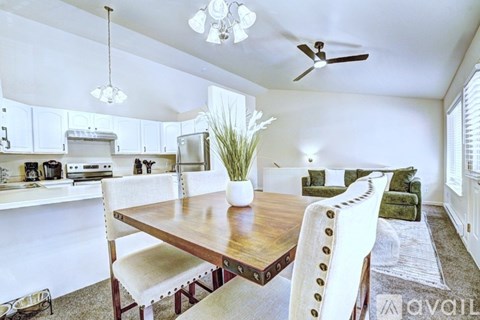 A dining room with a wooden table and chairs.
