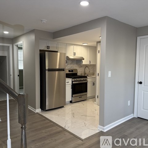 A kitchen with a refrigerator, oven, and microwave.