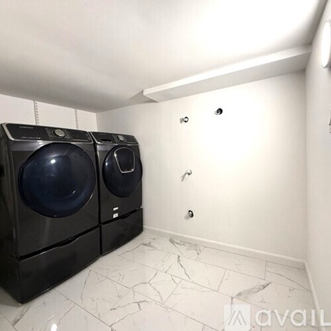 A laundry room with two front loading washing machines.